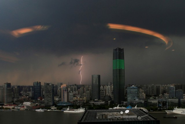 FILE PHOTO - A streak of lightning is seen above the skyline of Shanghai, China, August 19, 2016. Picture taken through a glass window. REUTERS/Aly Song/File Photo REUTERS PICTURES OF THE YEAR 2016 - SEARCH 'POY 2016' TO FIND ALL IMAGES