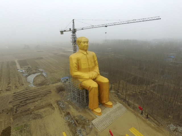 FILE PHOTO - A crane is seen next to a giant statue of Chinese late chairman Mao Zedong under construction near crop fields in a village of Tongxu county, Henan province, China, January 4, 2016. REUTERS/Stringer/File Photo ATTENTION EDITORS - THIS PICTURE WAS PROVIDED BY A THIRD PARTY. THIS PICTURE IS DISTRIBUTED EXACTLY AS RECEIVED BY REUTERS, AS A SERVICE TO CLIENTS. CHINA OUT. NO COMMERCIAL OR EDITORIAL SALES IN CHINA REUTERS PICTURES OF THE YEAR 2016 - SEARCH 'POY 2016' TO FIND ALL IMAGES