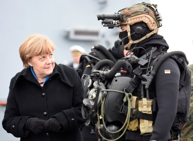 FILE PHOTO - German Chancellor Angela Merkel looks at a combat diver during her visit to Naval Base Command in Kiel, Germany, January 19, 2016. REUTERS/Fabian Bimmer/File Photo REUTERS PICTURES OF THE YEAR 2016 - SEARCH 'POY 2016' TO FIND ALL IMAGES