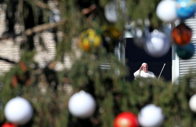 Pope Francis is seen through the Vatican Christmas tree as he leads the Angelus prayer in Saint Peter's Square at the Vatican December 8, 2016. REUTERS/Alessandro Bianchi