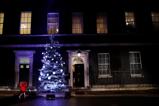 A girl looks at a Christmas tree in Downing Street in London, Britain December 8, 2016. REUTERS/Stefan Wermuth