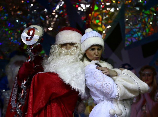 People dressed as Father Frost, the equivalent of Santa Claus, and Snow Maiden take part in the contest "Yolka-fest-2016" (Fir-festival-2016) in Minsk, Belarus December 9, 2016. REUTERS/Vasily Fedosenko