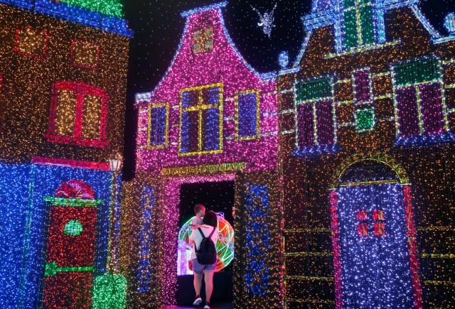 People tour a Christmas attraction featuring a display of more than 800,000 light bulbs in Universal Studios Singapore December 12, 2016. REUTERS/Edgar Su