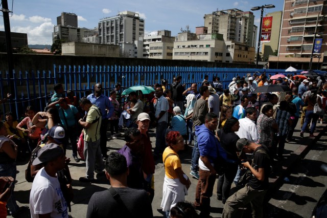 People queue to deposit their 100 bolivar notes, near Venezuela's Central Bank in Caracas, Venezuela December 16, 2016. REUTERS/Marco Bello