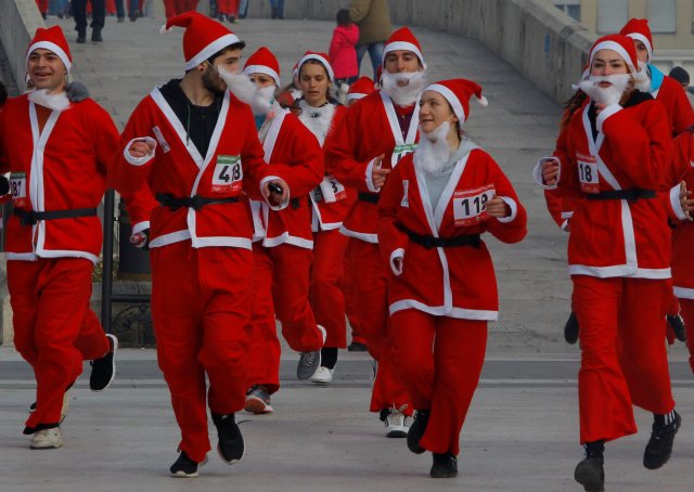 Runners dressed as Santa Claus take part in the annual Christmas race on the streets of Skopje, Macedonia December 25, 2016. REUTERS/Ognen Teofilovski