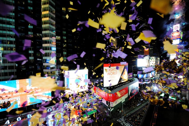 Volunteers throw a test batch of confetti into Times Square below from a balcony at the Marriott Marquis two hours before the New Year in the Manhattan borough of New York, December 31, 2016. REUTERS/Mark Kauzlarich