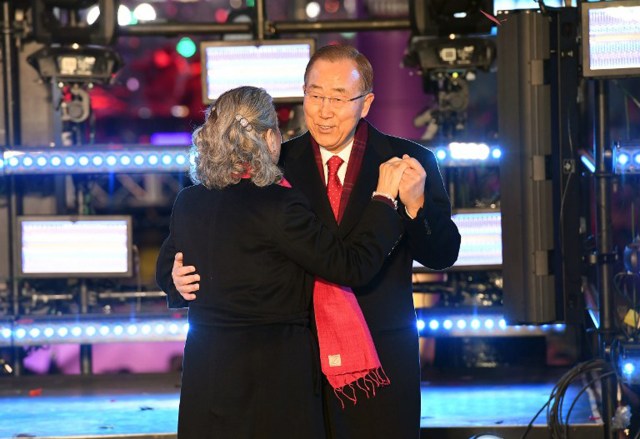 United Nations Secretary General Ban Ki-Moon and his wife Yoo Soon-taek dance on stage during New Year's Celebrations in Times Square on December 31, 2016 in New York City. / AFP PHOTO / ANGELA WEISS