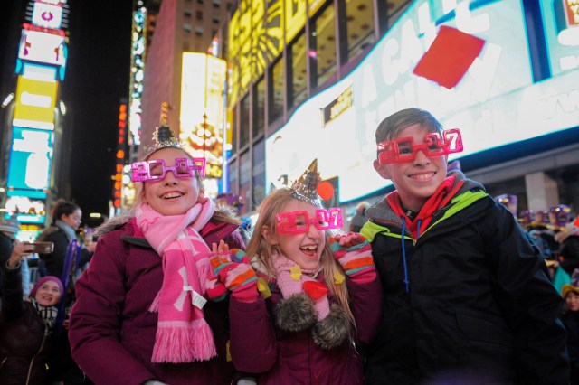 Children play with confetti to mark the new year in Times Square in New York, U.S. January 1, 2017. REUTERS/Stephanie Keith