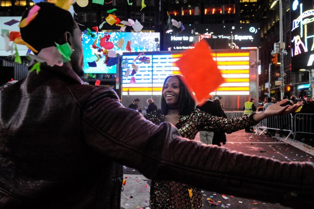 People play in confetti to mark the new year in Times Square in New York, U.S. January 1, 2017. REUTERS/Stephanie Keith