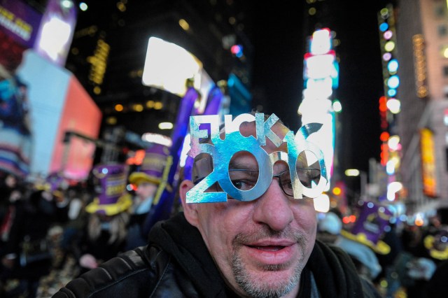 ATTENTION EDITORS - PICTURE CONTAINS EXPLETIVEA man wears party glasses to mark the new year in Times Square in New York, U.S. January 1, 2017. REUTERS/Stephanie KeithTEMPLATE OUT