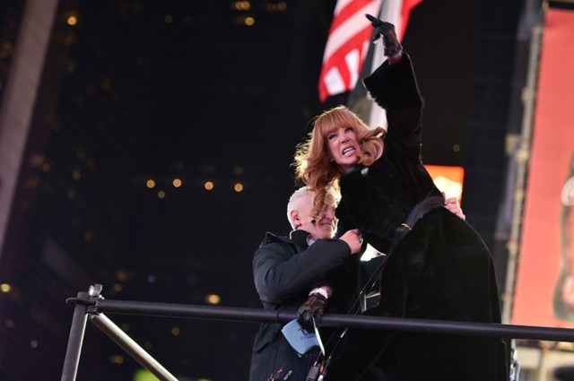 NEW YORK, NY - DECEMBER 31: Kathy Griffin Yells at Ryan Seacrest from the media riser while Anderson Cooper restrains her during New Year's Eve 2017 in Times Square at Times Square on December 31, 2016 in New York City.   Theo Wargo/Getty Images/AFP
