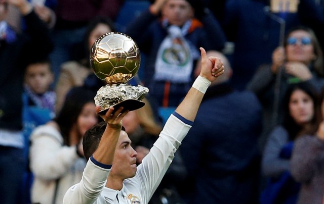 Football Soccer - Real Madrid v Granada - Spanish La Liga Santander - Santiago Bernabeu stadium, Madrid, Spain - 7/1/17 - Real Madrid's Cristiano Ronaldo holds his Ballon d'Or (Golden Ball) trophy to the crowd after winning the FIFA World Player of the Year 2016 award, before their Spanish first division soccer match against Granada. REUTERS/Juan Medina      TPX IMAGES OF THE DAY
