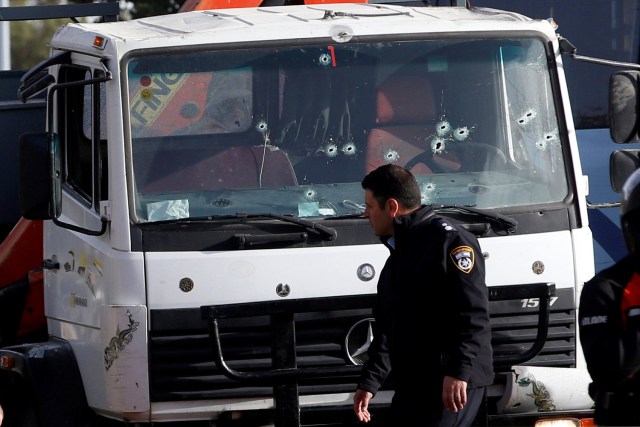 An Israeli policeman walks at the scene of a truck-ramming incident in Jerusalem January 8, 2017. REUTERS/Ronen Zvulun