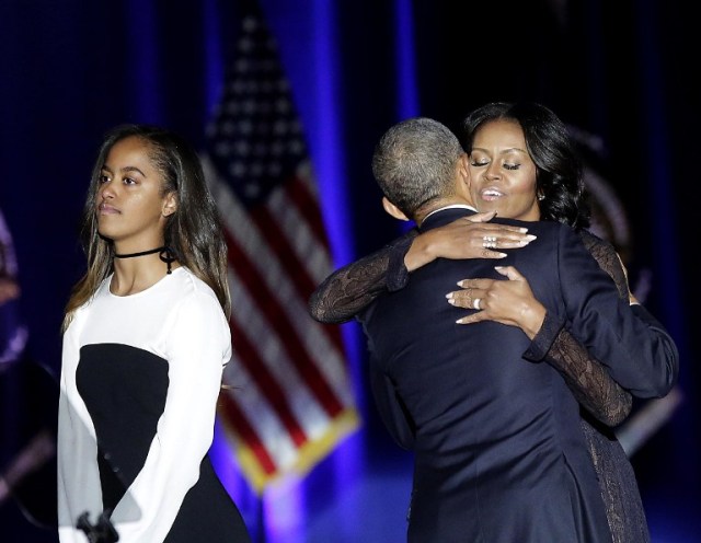US First Lady Michelle Obama (R) hugs US President Barack Obama as daughter Malia looks on after the President delivered his farewell address in Chicago, Illinois on January 10, 2017. Barack Obama closes the book on his presidency, with a farewell speech in Chicago that will try to lift supporters shaken by Donald Trump's shock election. / AFP PHOTO / Joshua LOTT