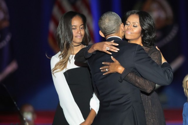 CHICAGO, IL - JANUARY 10: President Barack Obama embraces his wife Michelle and daughter Malia following his farewell speech to the nation on January 10, 2017 in Chicago, Illinois. President-elect Donald Trump will be sworn in the as the 45th president on January 20. Scott Olson/Getty Images/AFP