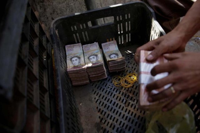Pilas de billetes de 100 bolívares en una cesta de plástico en un mercado en Caracas. 16 de diciembre de 2016. Pilas de billetes de 100 bolívares en una cesta de plástico en un mercado en Caracas REUTERS/Marco Bello