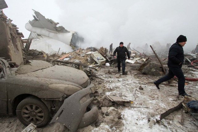 Rescue teams are seen are seen at the crash site of a Turkish cargo jet near Kyrgyzstan's Manas airport outside Bishkek, January 16, 2017.  REUTERS/Vladimir Pirogov