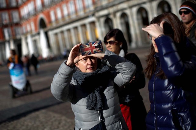A tourist takes a picture at Plaza Mayor square in Madrid, Spain, January 16, 2017. REUTERS/Juan Medina