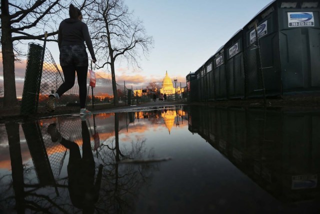 WASHINGTON, DC - JANUARY 18: A walks past portbale toilets set up in front of the U.S. Capitol building ahead of inauguration ceremonies for President-elect Donald Trump on January 18, 2017 in Washington, DC. Trump will be sworn in as the 45th U.S, president on January 20.   Mario Tama/Getty Images/AFP