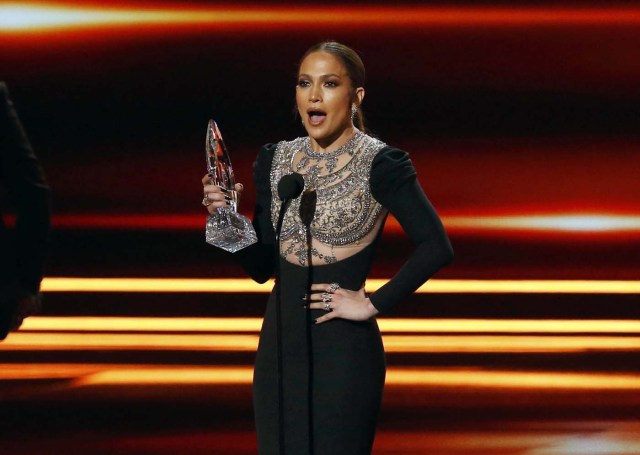 Actress Jennifer Lopez accepts the award for Favorite TV Crime Drama Actress as actors Dax Shepard (L) and Michael Pena look on during the People's Choice Awards 2017 in Los Angeles, California, U.S., January 18, 2017.   REUTERS/Mario Anzuoni