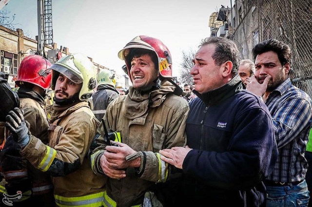 A firefighter reacts at the site of a collapsed high-rise building in Tehran, Iran January 19, 2017. Tasnim News Agency/Handout via REUTERS ATTENTION EDITORS - THIS PICTURE WAS PROVIDED BY A THIRD PARTY. FOR EDITORIAL USE ONLY. NO RESALES. NO ARCHIVE.