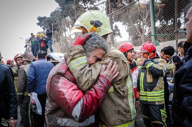 Firefighters react at the site of a collapsed high-rise building in Tehran, Iran January 19, 2017. Tasnim News Agency/Handout via REUTERS ATTENTION EDITORS - THIS PICTURE WAS PROVIDED BY A THIRD PARTY. FOR EDITORIAL USE ONLY. NO RESALES. NO ARCHIVE.