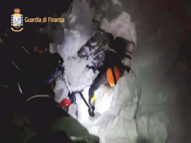 A photo taken from a video shows a rescuer entering the Hotel Rigopiano in Farindola, central Italy, hit by an avalanche, in this January 19, 2017 handout picture provided by Italy's Finance Police. Guardia Di Finanza/Handout via REUTERS   ATTENTION EDITORS - THIS IMAGE WAS PROVIDED BY A THIRD PARTY. EDITORIAL USE ONLY.