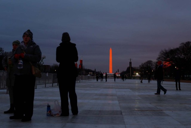 Supporters of U.S. President-elect Donald Trump gather in the foreground of the Washington Monument on the National Mall before Trump is to be sworn in in Washington U.S., January 20, 2017. REUTERS/Shannon Stapleton