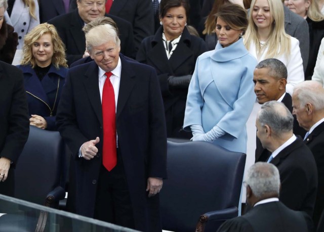 President-elect Donald Trump givs a thumbs up as President Barrack Obama (R) looks on before the inauguration ceremonies swearing in Donald Trump as the 45th president of the United States on the West front of the U.S. Capitol in Washington, U.S., January 20, 2017. REUTERS/Lucy Nicholson