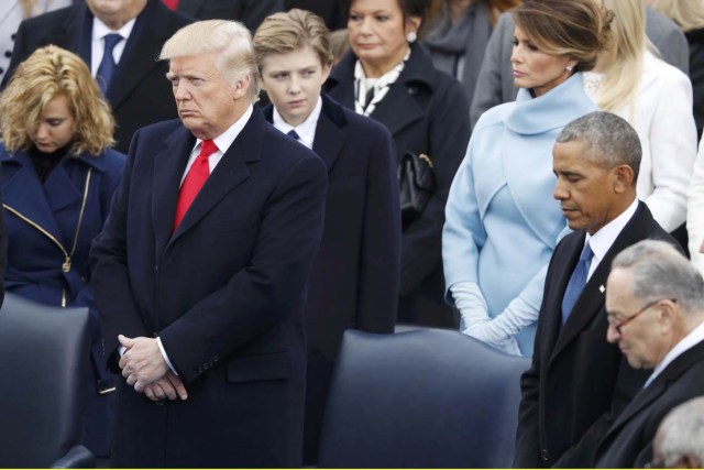 President-elect Donald Trump and President Barrack Obama (R) listen to the invocation before the inauguration ceremonies swearing in Donald Trump as the 45th president of the United States on the West front of the U.S. Capitol in Washington, U.S., January 20, 2017. REUTERS/Lucy Nicholson (UNITED STATES - Tags: POLITICS)
