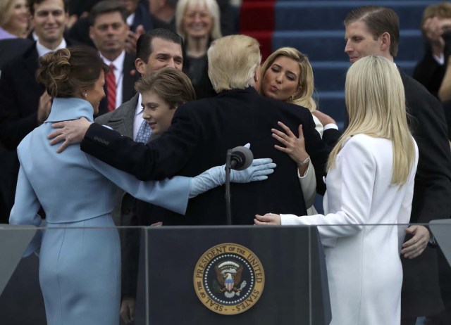 U.S. President Donald Trump embraces members of his family, wife Melania (L), and children Barron, Donald, Ivanka and Tiffany,after being sworn in during inauguration ceremonies at the Capitol in Washington, U.S., January 20, 2017. REUTERS/Carlos Barria