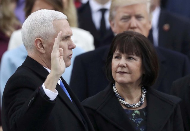 Vice President Mike Pence is sworn in as his wife Karen Pence watches during inauguration ceremonies swearing in Donald Trump as the 45th president of the United States on the West front of the U.S. Capitol in Washington, U.S., January 20, 2017. REUTERS/Carlos Barria