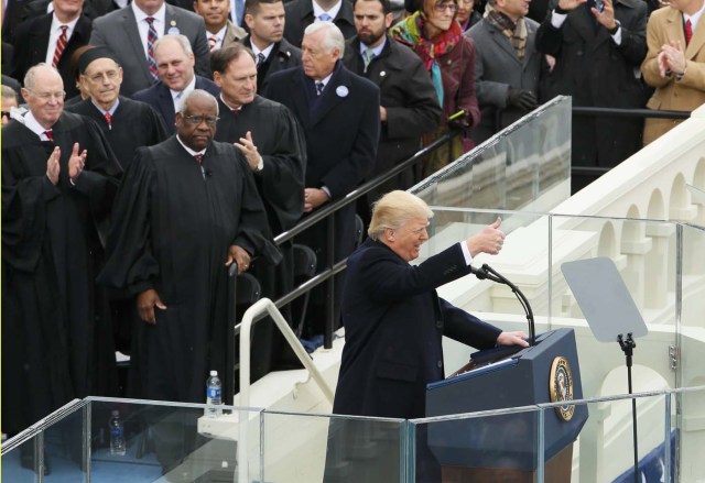 U.S. President Donald Trump givesa thumbs-up as Supreme Court justices Clarence Thomas, Anthony Kennedy, Stephen Breyer and Samuel Alito look on at the inauguration ceremonies swearing in Donald Trump as the 45th president of the United States on the West front of the U.S. Capitol in Washington, U.S., January 20, 2017. REUTERS/Rick Wilking