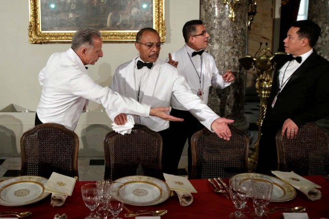 Waiters make final checks of a table prepared for U.S. President Donald Trump and members of Congress before the Inaugural Luncheon in Statuary Hall on Capitol Hill in Washington, U.S., January 20, 2017. REUTERS/Yuri Gripas