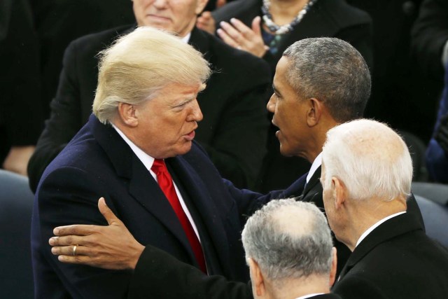 US President Donald Trump speaks with outgoing President Barack Obama during inauguration ceremonies at the U.S. Capitol in Washington, U.S., January 20, 2017. REUTERS/Kevin Lamarque