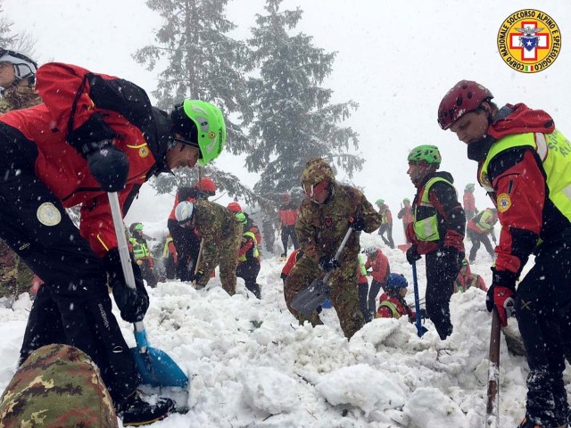 Rescue workers search in snow around Hotel Rigopiano in Farindola
