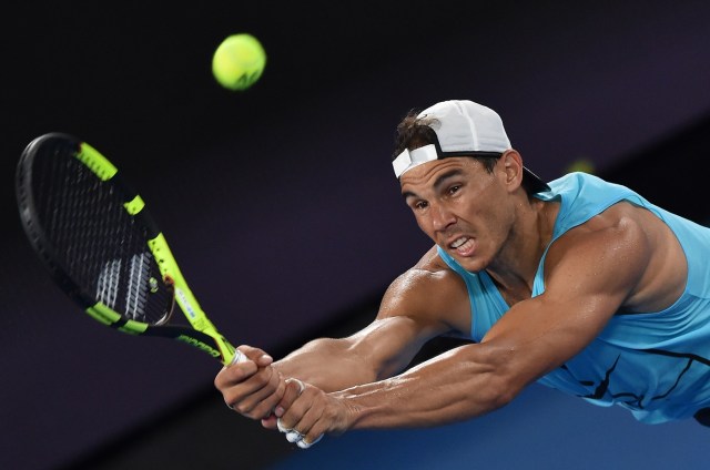 Rafael Nadal of Spain hits a return during a practice session ahead of the Australian Open tennis tournament in Melbourne on January 13, 2017. / AFP PHOTO / PAUL CROCK