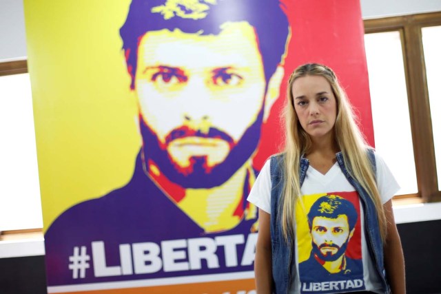 Lilian Tintori, wife of jailed Venezuelan opposition leader Leopoldo Lopez, poses for a picture in front of a poster depicting her husband at the office of the party Popular Will (Voluntad Popular) in Caracas, Venezuela January 18, 2017. Picture taken January 18, 2017. REUTERS/Carlos Garcia Rawlins
