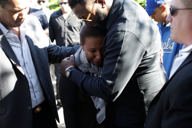 Former Boston Red Sox baseball player David Ortiz (also known as "Big Papi") conforts Marisol Hernandez, the mother of Yordano Ventura, a Kansas City Royals baseball player who died in a car crash, before the funeral in Las Terrenas, Dominican Republic