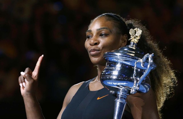 Tennis - Australian Open - Melbourne Park, Melbourne, Australia - 28/1/17 Serena Williams of the U.S. gestures as she holds her trophy after winning her Women's singles final match against Venus Williams of the U.S. .REUTERS/Edgar Su