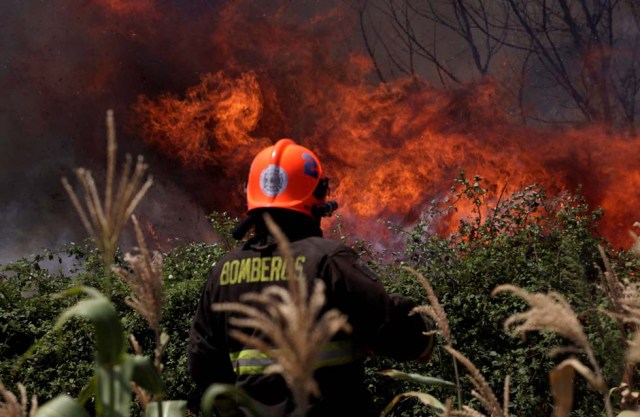 A firefighter is pictured during a forest fire in San Carlos town, at the country's central-south regions,