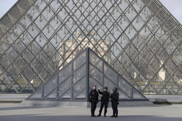 French police secure the site near the Louvre Pyramid in Paris, France, February 3, 2017 after a French soldier shot and wounded a man armed with a knife after he tried to enter the Louvre museum in central Paris carrying a suitcase, police sources said. REUTERS/Christian Hartmann