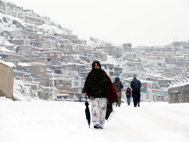 Una mujer afgana camina por una calle nevada en Kabul, Afganistán. 5 febrero 2017. Decenas de personas perdieron la vida en Afganistán y Pakistán por las fuertes nevadas y las avalanchas ocurridas durante el fin de semana. REUTERS/Omar Sobhani