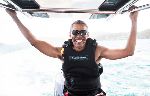 Former U.S. President Barack Obama sits on a boat during a kite surfing outing with British businessman Richard Branson during his holiday on Branson's Moskito island, in the British Virgin Islands, in a picture handed out by Virgin on February 7, 2017. Jack Brockway/Virgin Handout via REUTERS FOR EDITORIAL USE ONLY