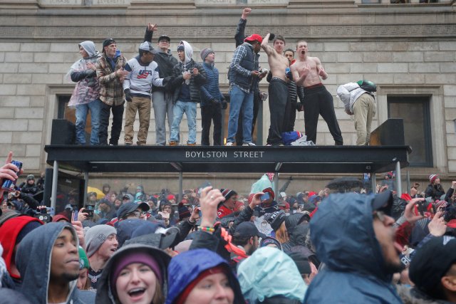 Fans watch the New England Patriots victory parade through the streets of Boston after winning Super Bowl LI, in Boston
