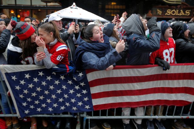 Fans watch the New England Patriots victory parade through the streets of Boston after winning Super Bowl LI, in Boston