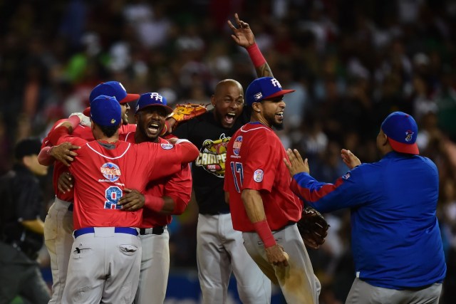 Players of Criollos de Caguas from Puerto Rico, celebrate their victory against Aguilas de Mexicali from Mexico during the final of Caribbean Baseball Series, at the Tomateros stadium, in Culiacan, Sinaloa State, Mexico, on February 7, 2017. / AFP PHOTO / RONALDO SCHEMIDT