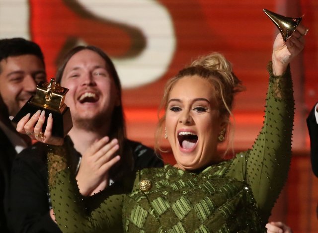 Adele breaks the Grammy for Record of the Year for "Hello" after having it presented to her at the 59th Annual Grammy Awards in Los Angeles, California, U.S., February 12, 2017. REUTERS/Lucy Nicholson  TPX IMAGES OF THE DAY     TPX IMAGES OF THE DAY