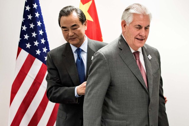 US Secretary of State Rex Tillerson (R) and China's Foreign Minister Wang Yi walk to their seats before a meeting on the sidelines of a gathering of Foreign Ministers of the G20 leading and developing economies at the World Conference Center in Bonn, western Germany, February 17, 2017.  REUTERS/Brendan Smialowski/Pool