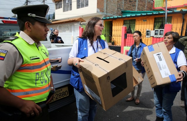 Workers of the Electoral National Council carry electoral materials during a program for people with disabilities to vote in advance in the Sunday's presidential election, in Quito, Ecuador, February 17, 2017. REUTERS/Mariana Bazo